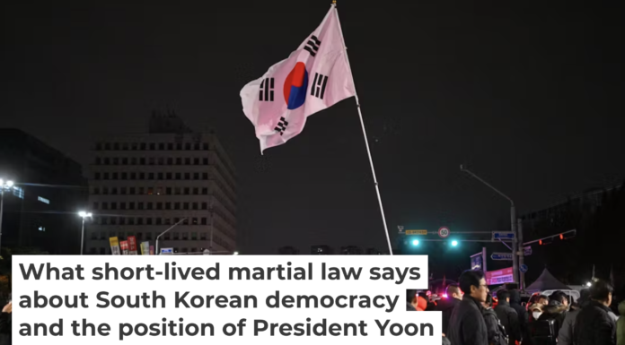 A man holds the South Korean flag outside the National Assembly in Seoul on Dec. 4, 2024, after President Yoon Suk Yeol declared emergency martial law. Anthony Wallace/AFP/Getty Images